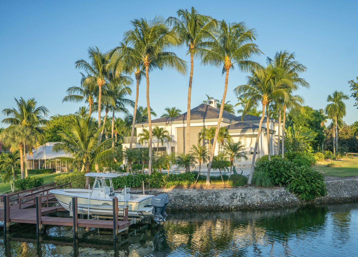 Waterfront Southwest Florida home surrounded by palm trees